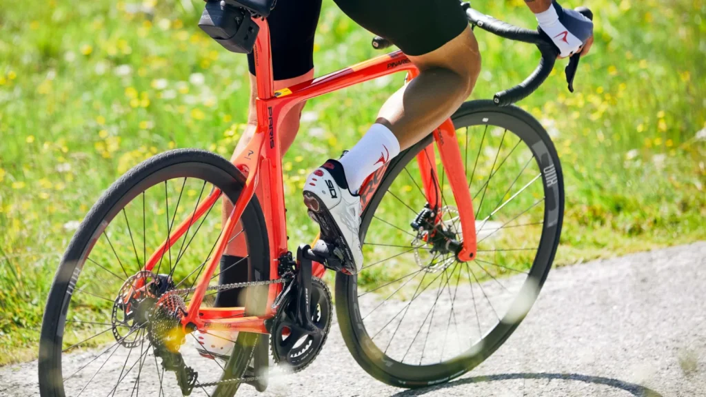 Cyclist riding a red Pinarello Paris road bike