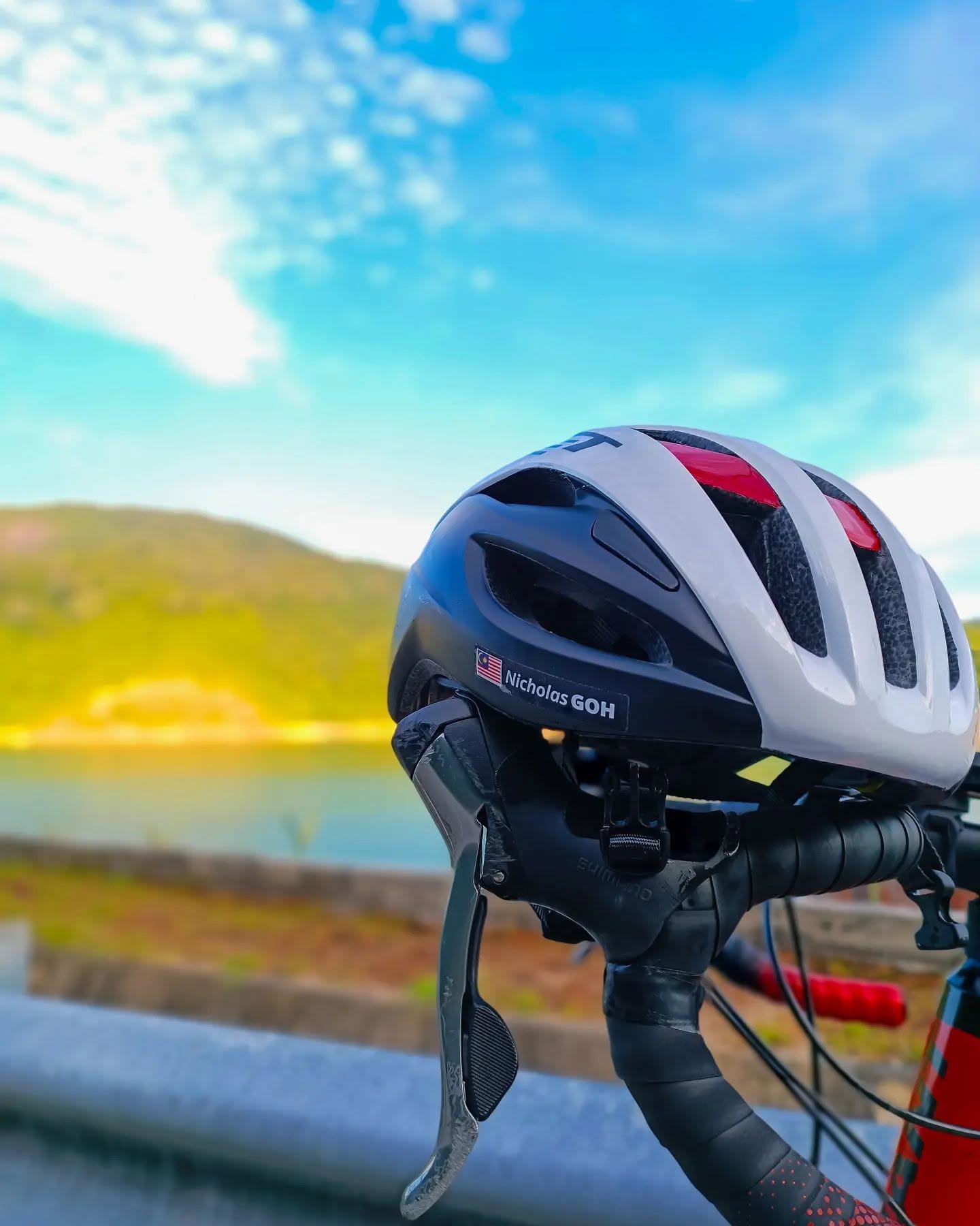 Cycling helmet with a personalised name sticker in a mountain setting