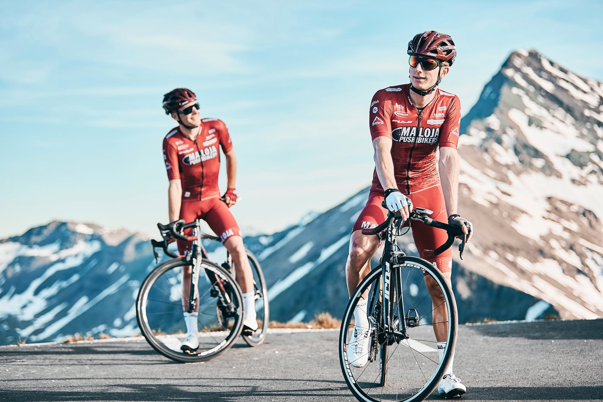 Two cyclists with road bikes in a mountain landscape