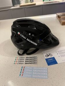 Cycling helmet beside a personalised Pegatin name sticker pack