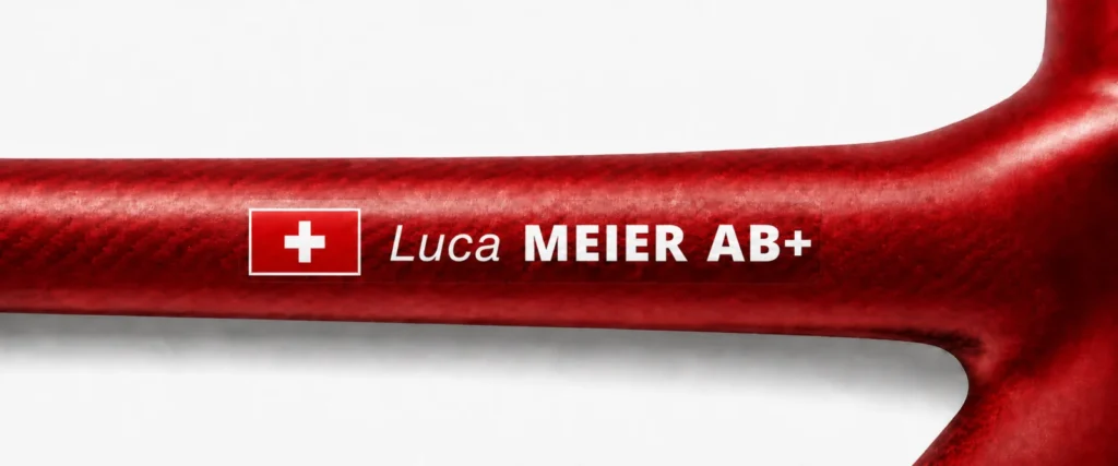 Swiss name and blood type sticker on a red bike frame
