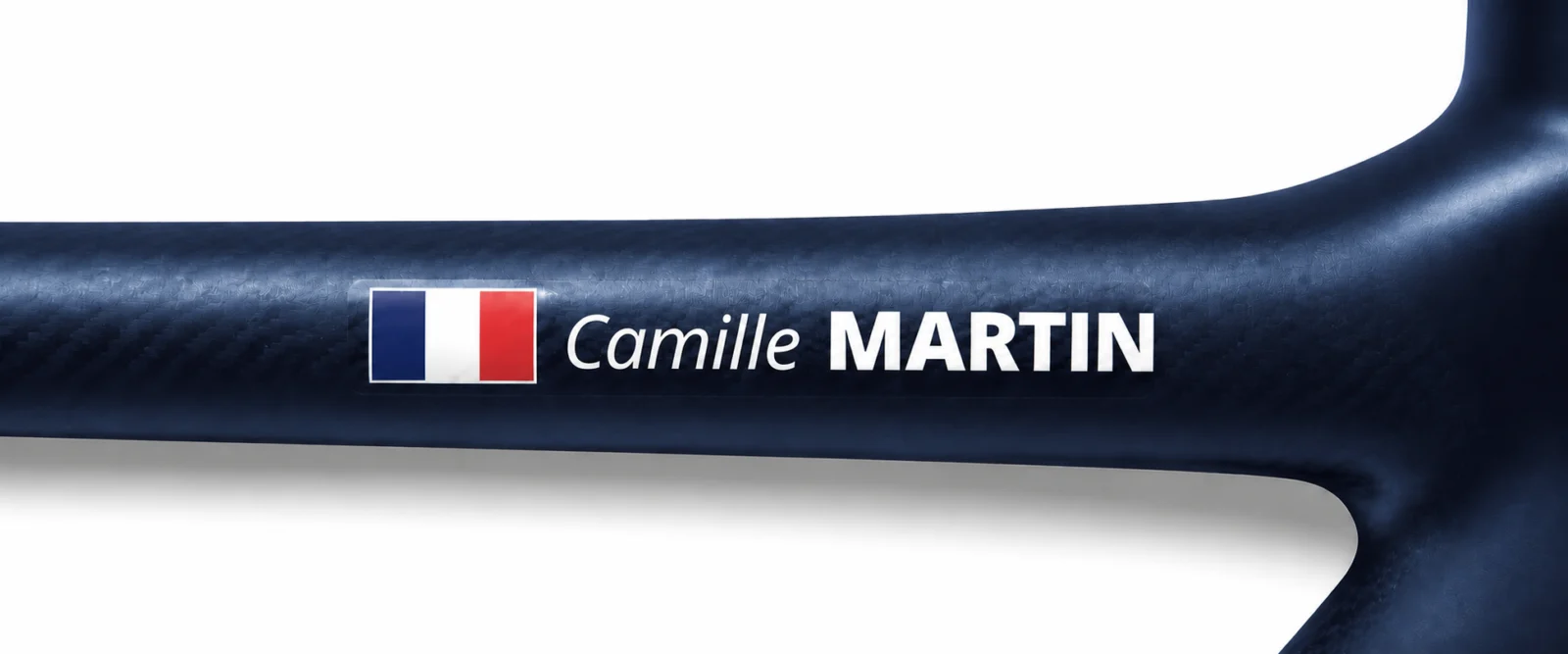 Close-up of a Pegatin name and flag sticker on a bicycle top tube
