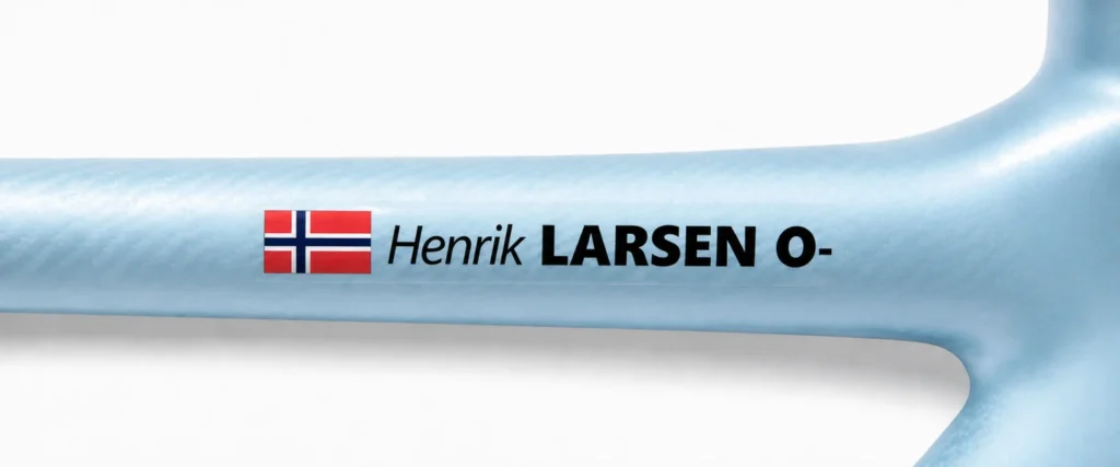 Norwegian name and blood type sticker on a light blue bike frame