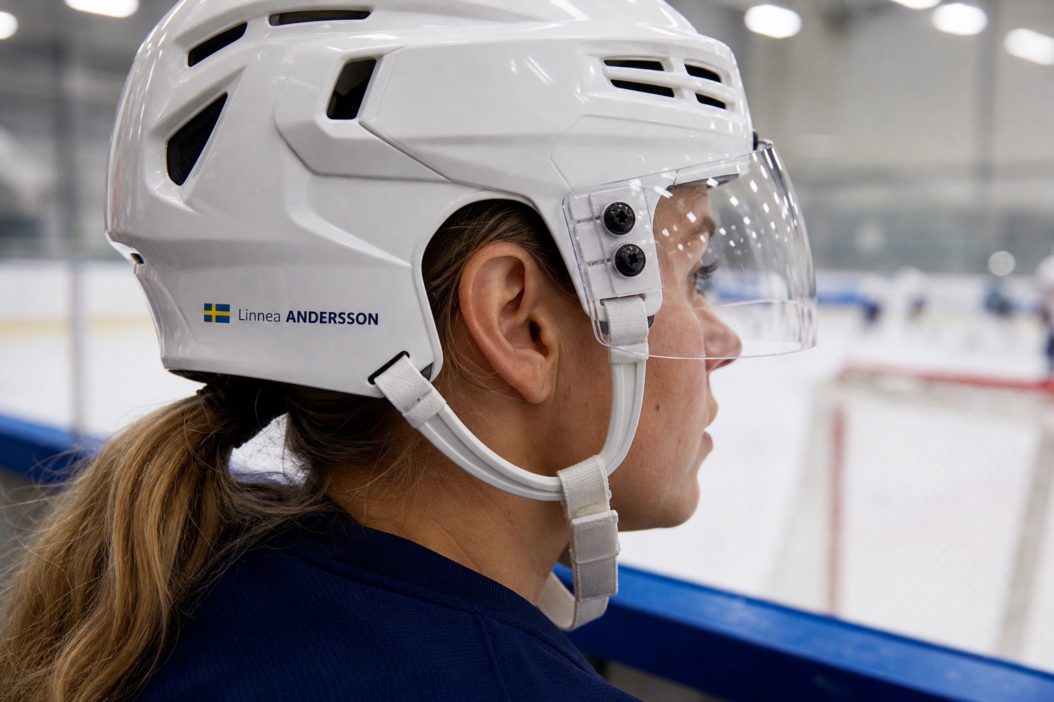 Ice hockey helmet name sticker with Sweden flag and Linnea ANDERSSON on a white player helmet
