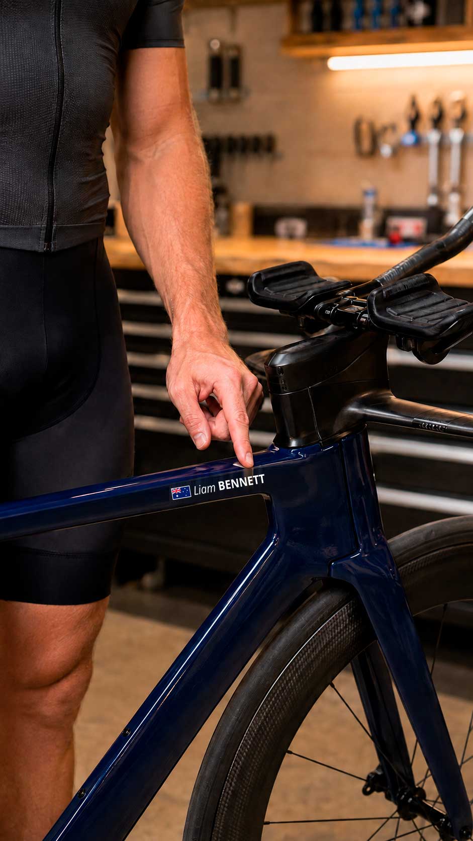 Personalised name sticker with an Australian flag on the top tube of a blue triathlon bike