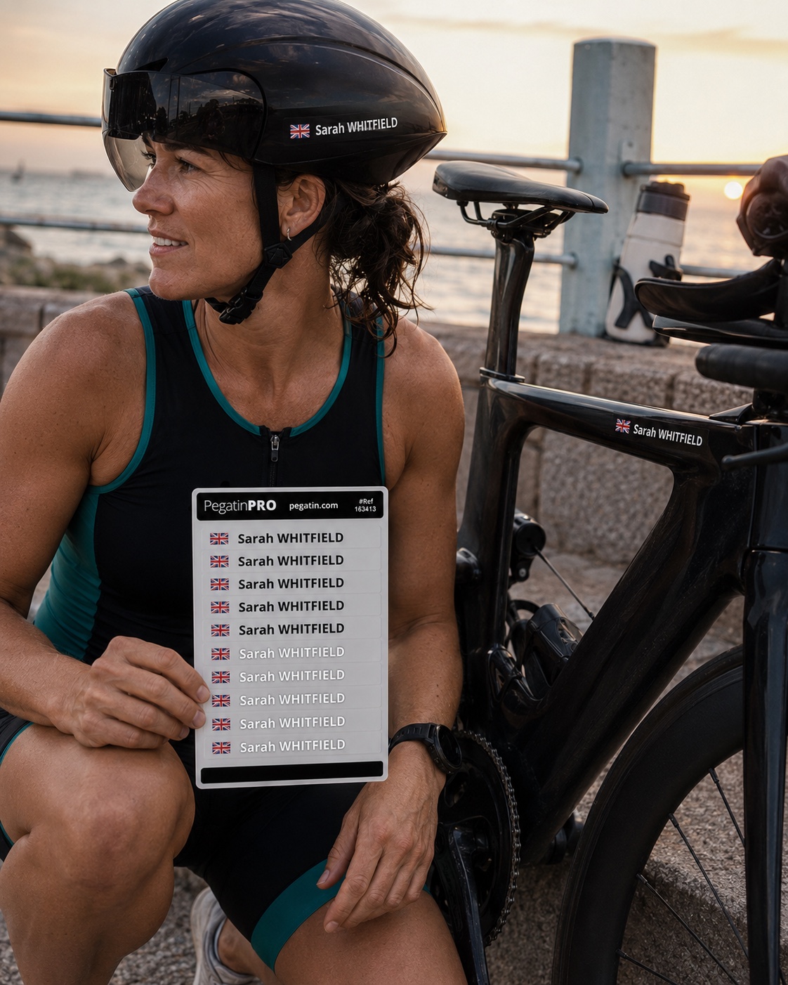 Triathlete with personalised name and flag stickers on her aero helmet and triathlon bike